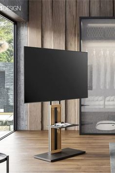 a flat screen tv sitting on top of a metal stand in front of a sliding glass door