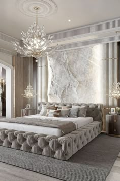 a large bed sitting in the middle of a bedroom next to a chandelier