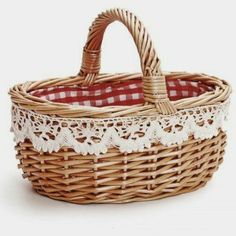 a wicker basket with red and white checkered cloth on the bottom is shown