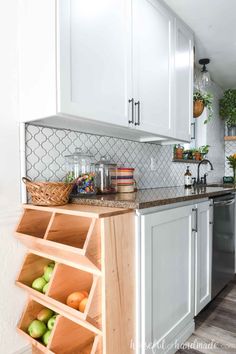 a kitchen with white cabinets and wooden shelves