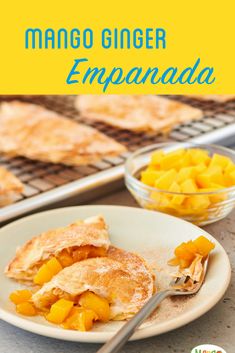 mango ginger empanada on a plate with a fork and bowl of fruit in the background