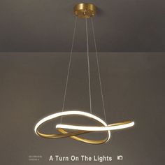 a modern light fixture hanging from the ceiling with an advertisement underneath it that reads, a turn on the lights