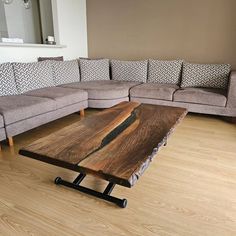 a living room with couches and a wooden coffee table in it's center