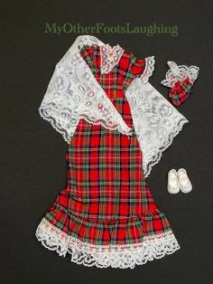 "MANUFACTURER: Pedigree® RELATES TO: DCM, Marx, Schuco, Collectible UK Doll, Barbie Clone STYLE/REF No: \"Tartan Touch\" 44321 - Out & About Fashions DETAILS: Excellent 1979 Sindy® tartan evening dress with a lace shawl and matching evening bag. The floor length dress is a red tartan patterned cotton with the front of the bodice backed with white fabric stiffener, short puffed sleeves, a square neckline, and trimmed with white nylon lace. The back has 2 chrome color poppers. The triangle shawl i Fabric Stiffener, Chrome Color, Triangle Shawl, Sindy Doll, Triangle Shawls, Doll Barbie, White Tassel, Floor Length Dress, Lace Shawl