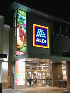 an aldi store at night with its lights on