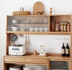 the shelves are filled with dishes and wine bottles