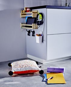 a bed and desk in a room with various items on the floor next to it