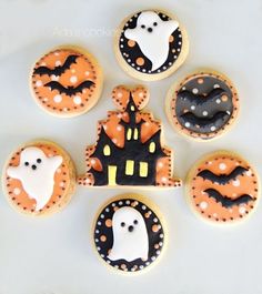 decorated cookies in the shape of houses and ghostes