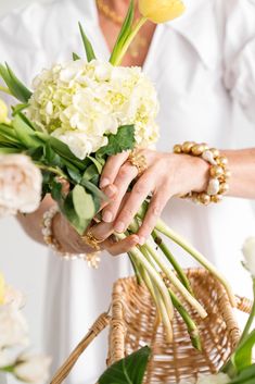 a woman holding a bouquet of flowers in her hands