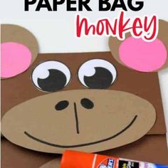 a paper bag with a monkey face on it and some candy in front of it