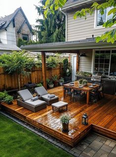 an outdoor deck with chairs and table next to a backyard area that is fenced in