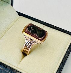 This listing is for a fabulous ring crafted of solid 12k rose gold and featuring a hand carved intaglio as shown in the photos. The setting features a period style and the intaglio measures approximately 10 x 15mm.  Features a lovely profile of a young Roman soldier. Ring is crafted of solid 12k rose gold with a wonderful period mounting.  Band measures approximately 5mm in width.  Not hallmarked but as been tested as 12k gold.  The ring weighs approximately 3.59 grams and is in wonderful condit Vintage Carved Rings For Gift, Lovely Profile, Roman Soldiers, Ring Crafts, Ring Size 7, Statement Rings, The Ring, Insurance, Seattle