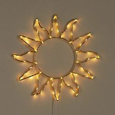 a light up sunburst is hanging on the wall