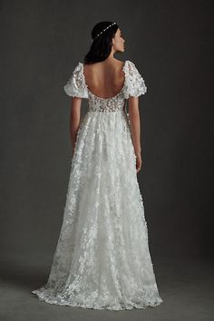 a woman in a wedding dress looking back