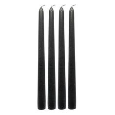 three black candles sitting next to each other