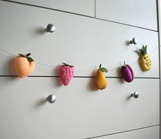 fruit and vegetable magnets are hanging on the wall