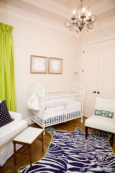 a baby's room is decorated in white and blue with zebra prints on the rug