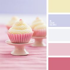 three cupcakes with white frosting on a pink and purple tablecloth, one is