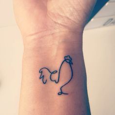 a small wrist tattoo with a chicken on it