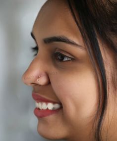 a close up of a woman with a nose piercing