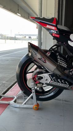 a motorcycle is parked in a garage with its tire on the ground next to it