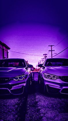 two cars parked next to each other in front of a purple sky