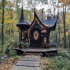 a small wooden house in the woods surrounded by trees