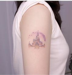 a woman's arm with a castle tattoo on the left side of her arm