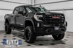 a large black truck parked in a garage