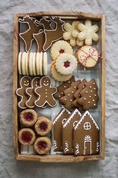 a wooden box filled with lots of different types of cookies