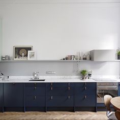 the kitchen is clean and ready for us to use it's counters are blue with brass pulls