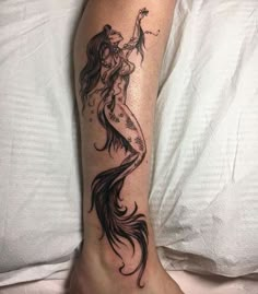 a woman's leg with a tattoo on it