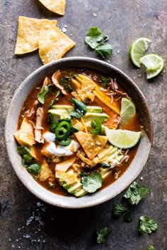 a bowl filled with tortilla soup and garnished with cilantro