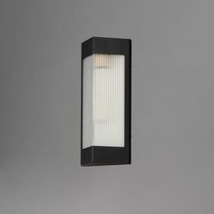 an outdoor wall light on the side of a gray wall with a white strip across it