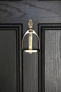 a black door with a gold handle on it