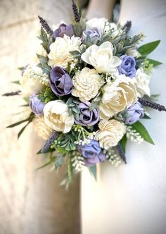 a bridal bouquet with purple and white flowers