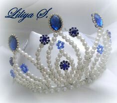 the tiara is adorned with blue and white pearls