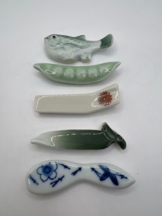 four ceramic objects are arranged on a white surface