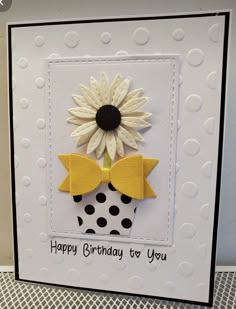 a birthday card with a sunflower in a polka dot cupcake on the front