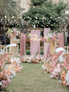 an outdoor wedding setup with pink and white flowers