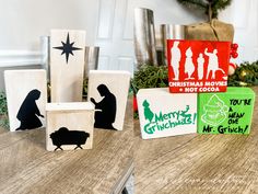 wooden blocks decorated with christmas silhouettes on a table