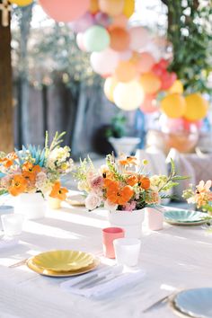 the table is set with flowers and plates