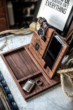 a wooden watch and other items on a tray