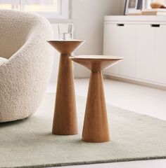 two wooden tables sitting on top of a rug