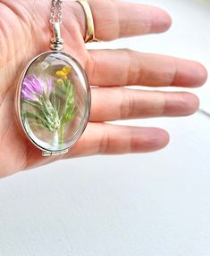 sterling silver Large oval Beveled glass locket necklace, oval hollow glass locket necklace, heirloom glass locket with inside space, Wedding ring locket Please note that these are the sterling silver version of the larger size (40mm) beveled glass lockets with 6mm space inside so you can add stones or plain gold band rings inside (To give you an idea, you can fit 4 USD quarters inside). I have another listing for smaller size (20 mm) glass lockets with the same 6mm in depth. The oval one is 30* Vintage Pressed Flowers Jewelry Keepsake, Vintage Pressed Flowers Keepsake Jewelry, Dainty Oval Pendant Locket Jewelry, Silver Locket Necklace With Birth Flower For Anniversary, Heirloom Oval Pendant Jewelry Gift, Vintage Silver Jewelry With Pressed Flowers, Heirloom Style Cabochon Jewelry As Gift, Heirloom Cabochon Jewelry As Gift, Heirloom Cabochon Jewelry Gift