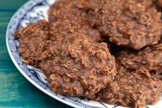 a plate filled with chocolate oatmeal cookies on top of a blue and white plate