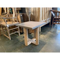 a wooden table sitting next to chairs in a room filled with wood and other furniture