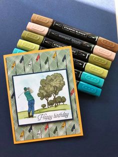 some crayons are sitting on a table next to markers and a card that says happy birthday