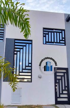 a white and blue building with black shutters