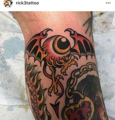 a man's leg with a dragon tattoo on it and an eye in the middle